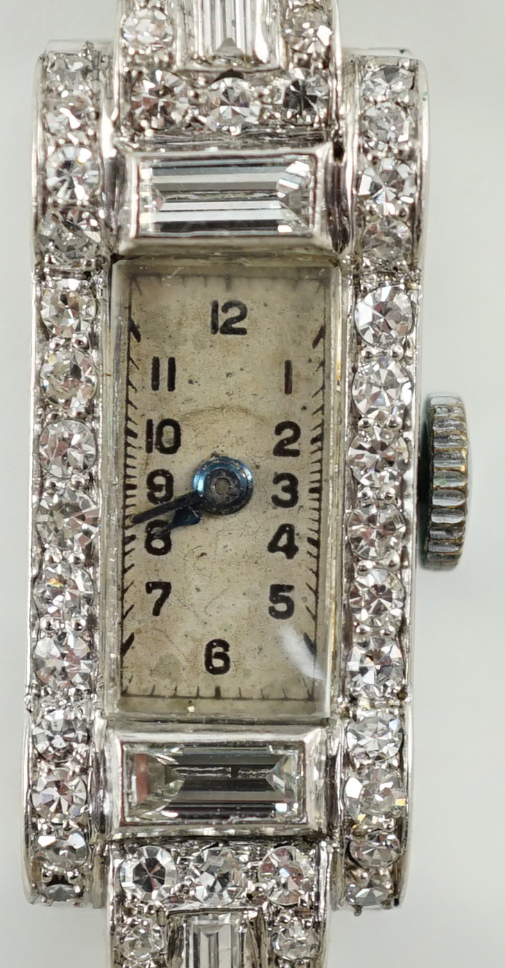 A lady's 1930's/1940's platinum, baguette and round cut diamond set rectangular dial manual wind cocktail watch, on a white gold and baguette and round cut diamond set bracelet, with Asprey box